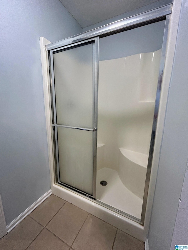 bathroom featuring an enclosed shower and tile patterned floors