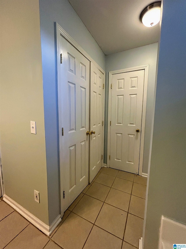 hall with light tile patterned flooring