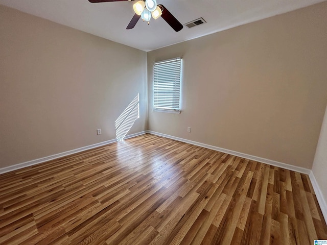 spare room featuring hardwood / wood-style floors and ceiling fan