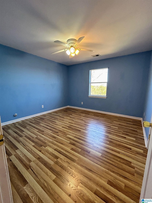 unfurnished room with hardwood / wood-style flooring and ceiling fan