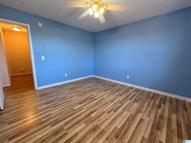 empty room with ceiling fan and wood-type flooring