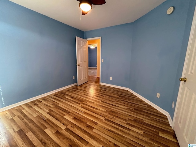 unfurnished bedroom with ceiling fan and hardwood / wood-style floors