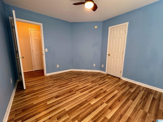 unfurnished bedroom featuring hardwood / wood-style flooring and ceiling fan