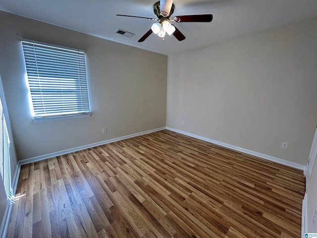 empty room featuring ceiling fan and hardwood / wood-style floors