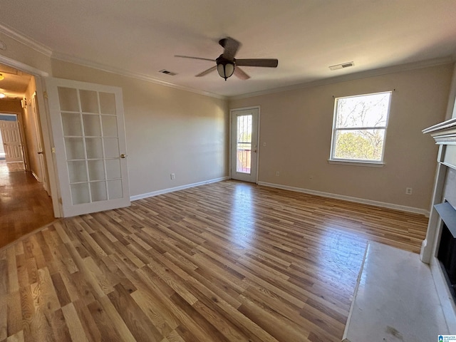 unfurnished living room with crown molding, ceiling fan, and hardwood / wood-style floors