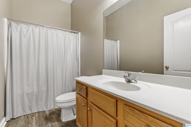 bathroom featuring vanity, hardwood / wood-style floors, and toilet