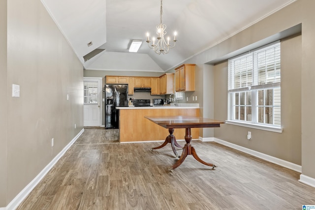 kitchen featuring light brown cabinetry, decorative light fixtures, light wood-type flooring, kitchen peninsula, and black appliances