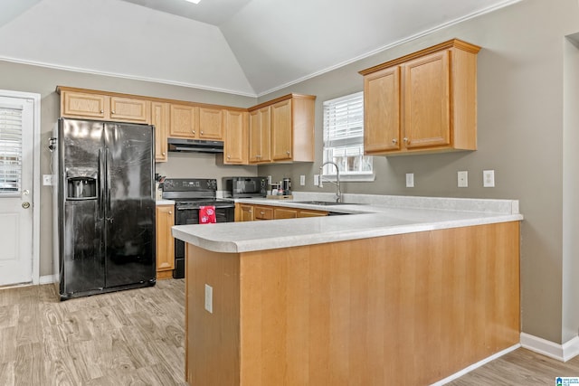 kitchen with sink, light hardwood / wood-style floors, black appliances, vaulted ceiling, and kitchen peninsula