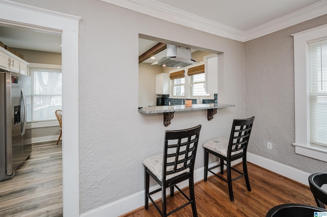 interior space featuring ornamental molding and hardwood / wood-style floors