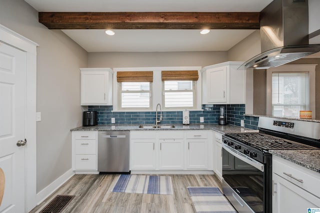 kitchen with white cabinetry, sink, island exhaust hood, stainless steel appliances, and light stone countertops