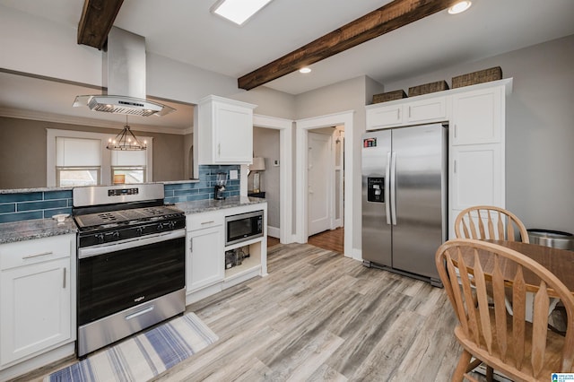 kitchen featuring white cabinetry, island range hood, stainless steel appliances, light stone countertops, and decorative backsplash