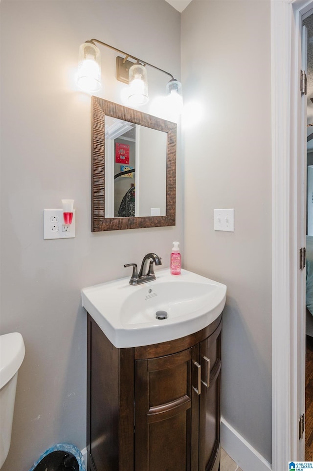 bathroom featuring vanity and toilet