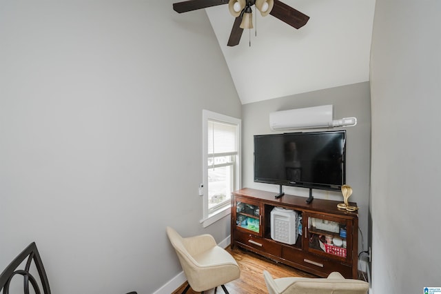 living room featuring a wall mounted air conditioner, hardwood / wood-style flooring, vaulted ceiling, and ceiling fan