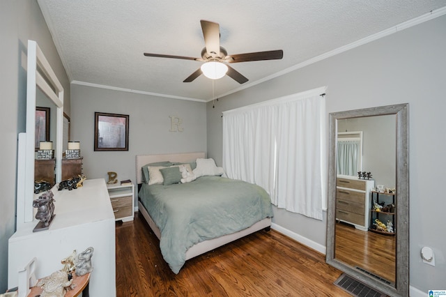 bedroom with dark hardwood / wood-style flooring, ceiling fan, crown molding, and a textured ceiling