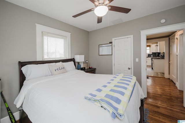 bedroom with ceiling fan and dark hardwood / wood-style floors