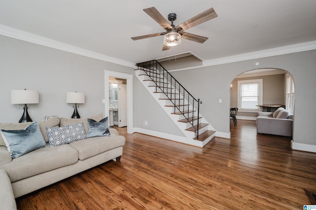 living room with wood-type flooring, ornamental molding, and ceiling fan