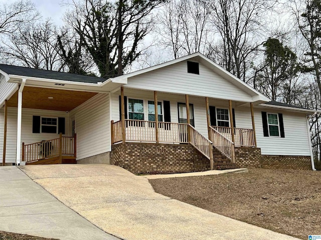 view of front of property featuring a carport and covered porch