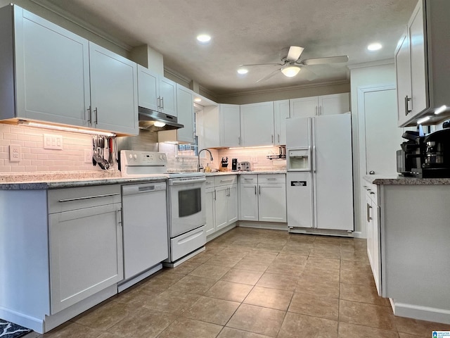 kitchen with sink, white appliances, ceiling fan, tasteful backsplash, and white cabinets