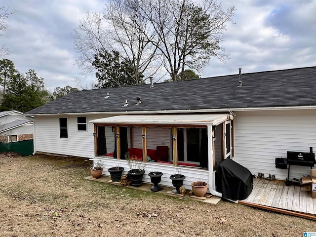 rear view of house featuring a wooden deck