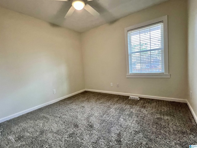 carpeted empty room featuring ceiling fan