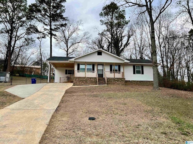 view of front of property with a carport, covered porch, and a front lawn