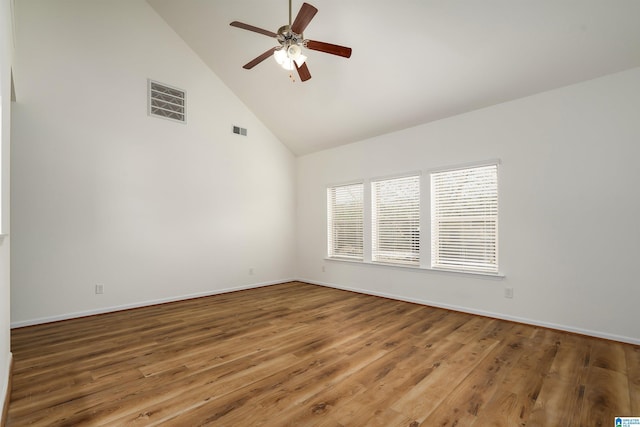 spare room with ceiling fan, wood-type flooring, and high vaulted ceiling