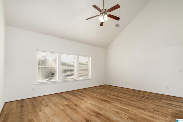 empty room with ceiling fan, high vaulted ceiling, and hardwood / wood-style floors