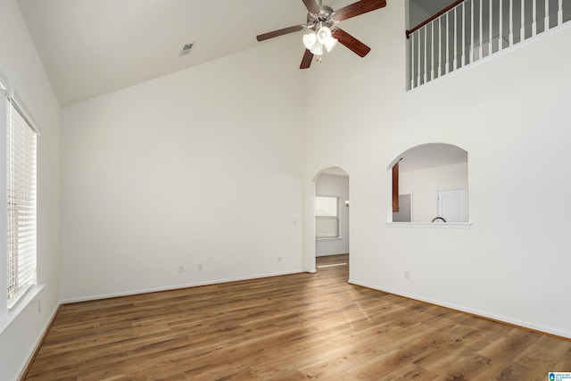 unfurnished room featuring ceiling fan, hardwood / wood-style floors, and high vaulted ceiling