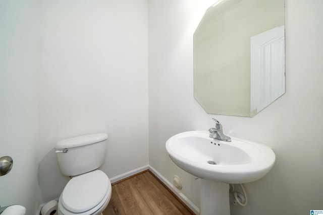 bathroom with wood-type flooring and toilet