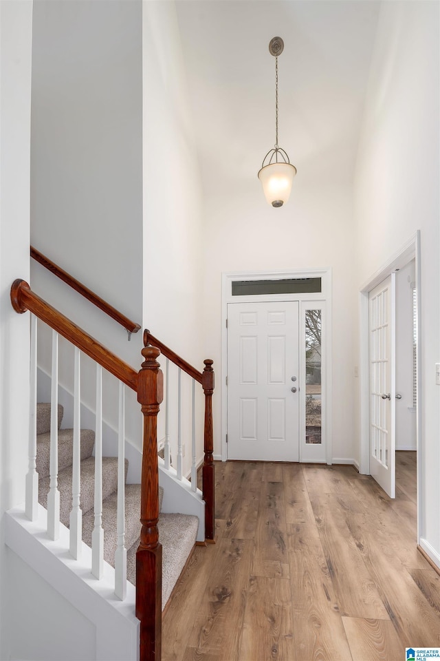 entrance foyer featuring a high ceiling and light hardwood / wood-style flooring