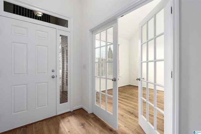 foyer entrance featuring wood-type flooring and french doors