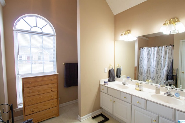 bathroom featuring vanity and lofted ceiling