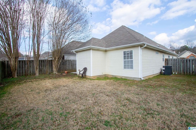 view of home's exterior featuring cooling unit and a lawn