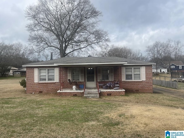 view of front of house with a porch and a front lawn