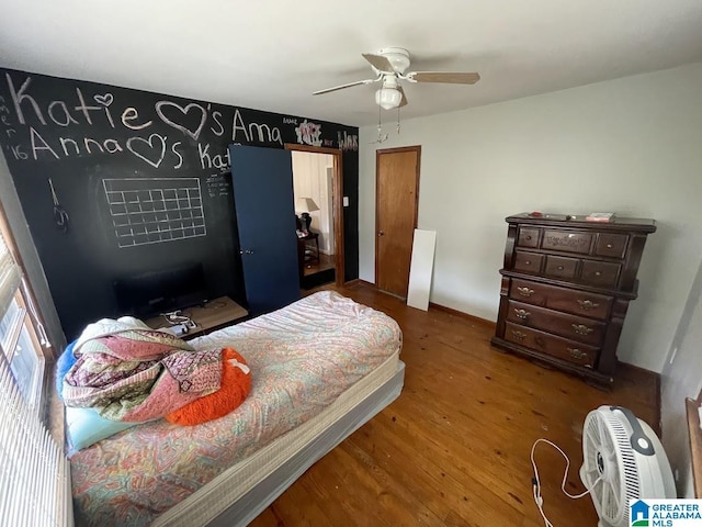 bedroom featuring wood-type flooring and ceiling fan