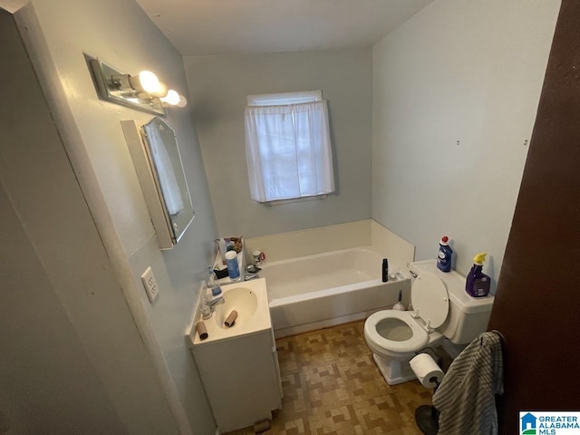 bathroom with vanity, toilet, and a bathing tub