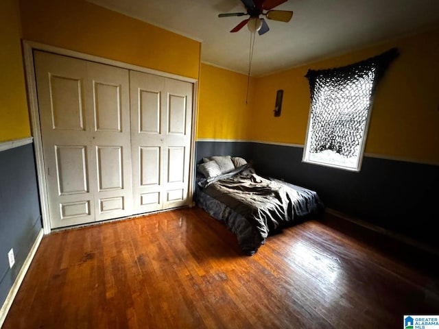 bedroom featuring hardwood / wood-style floors, ceiling fan, and a closet