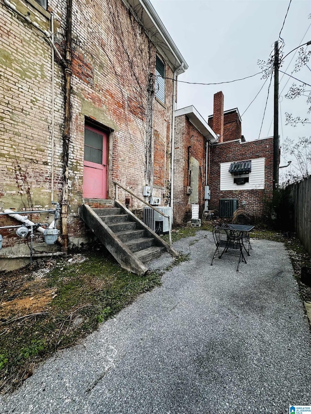 view of property exterior with central AC unit and a patio area