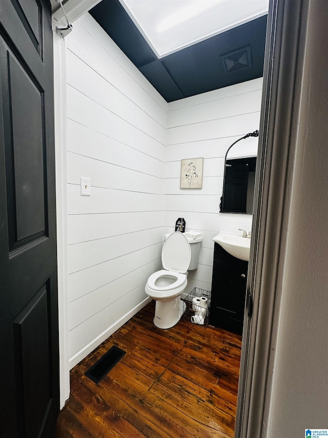 bathroom with vanity, hardwood / wood-style floors, and toilet