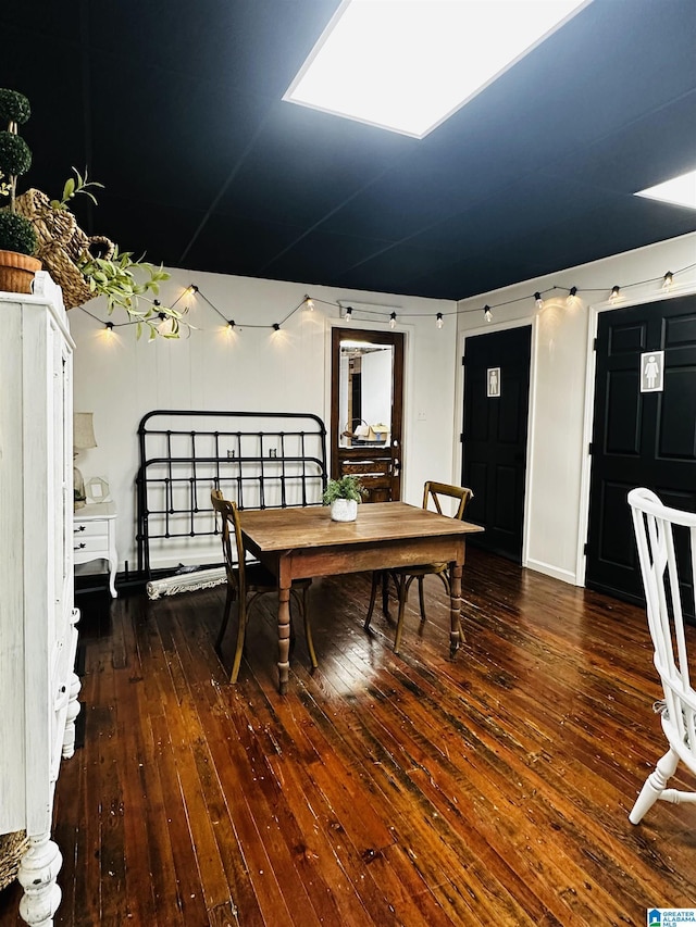 dining space with dark hardwood / wood-style flooring