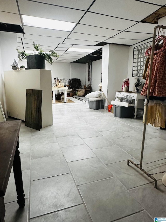 basement featuring a paneled ceiling