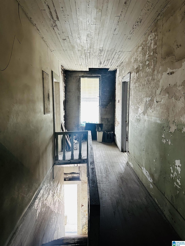 corridor with wood ceiling and hardwood / wood-style flooring