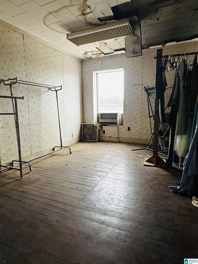 basement with cooling unit and hardwood / wood-style floors