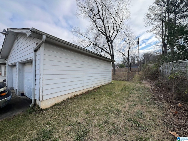 view of side of property with a garage and a lawn