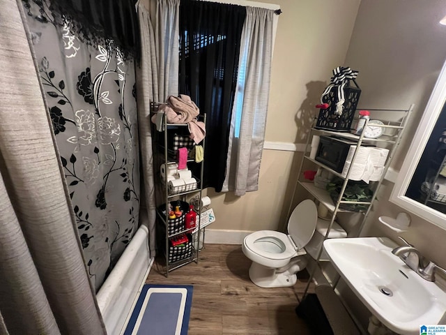 full bathroom featuring shower / bath combination with curtain, toilet, sink, and hardwood / wood-style floors