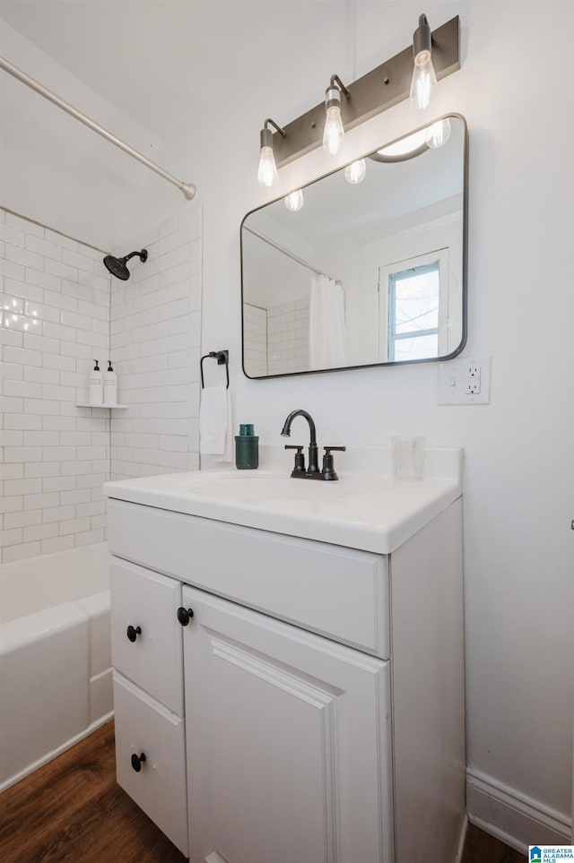 bathroom with vanity, hardwood / wood-style floors, and shower / bath combo