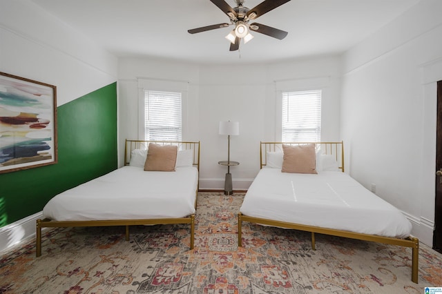 bedroom with multiple windows and ceiling fan