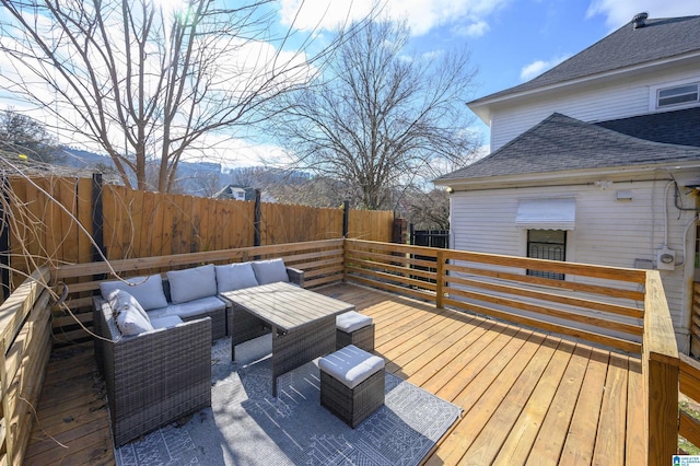 wooden terrace with an outdoor hangout area