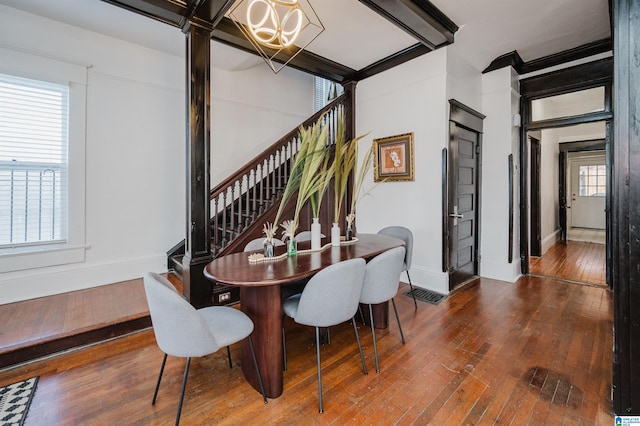 dining space with a notable chandelier and dark wood-type flooring