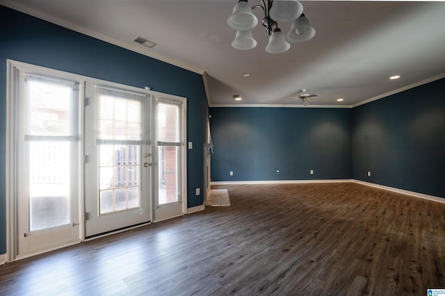 empty room featuring dark hardwood / wood-style flooring, a wealth of natural light, and ornamental molding